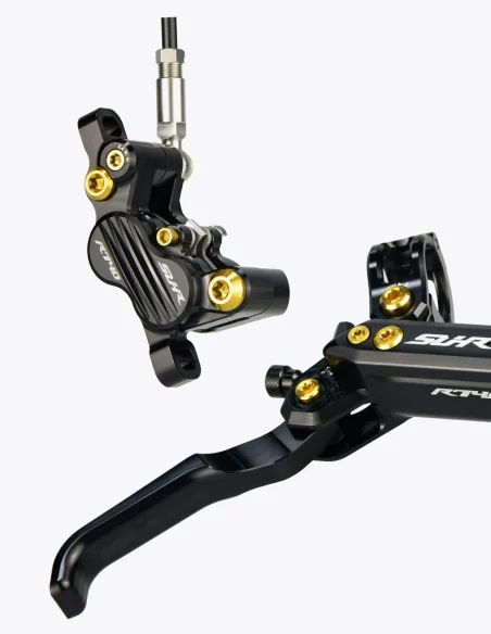 Primer plano de los Frenos SUHR en color negro con tornillos de titanio en color dorado